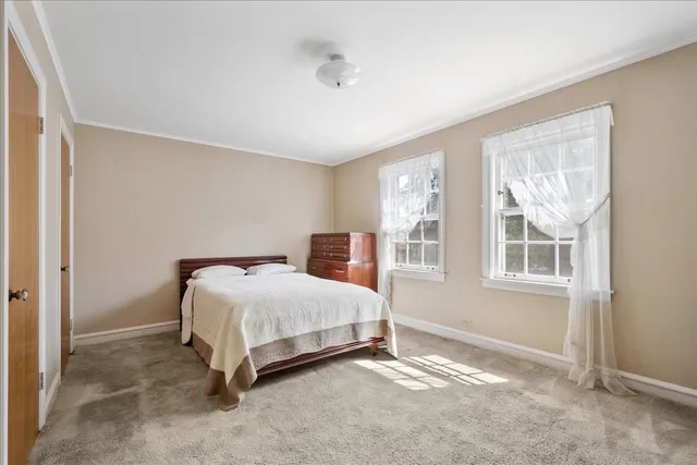 a bedroom with a bed lamp and a window