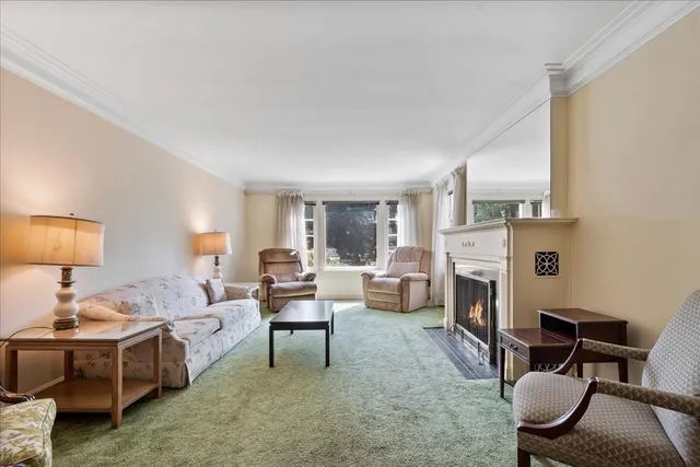 a living room with furniture a fireplace and a table