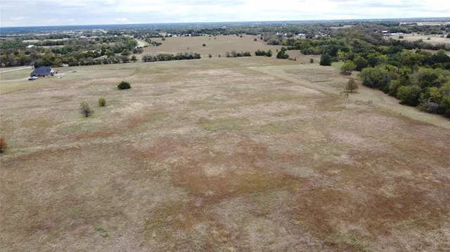 an aerial view of a houses with a yard
