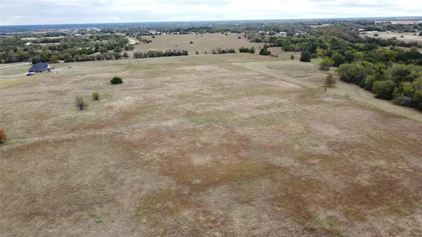 an aerial view of a houses with a yard