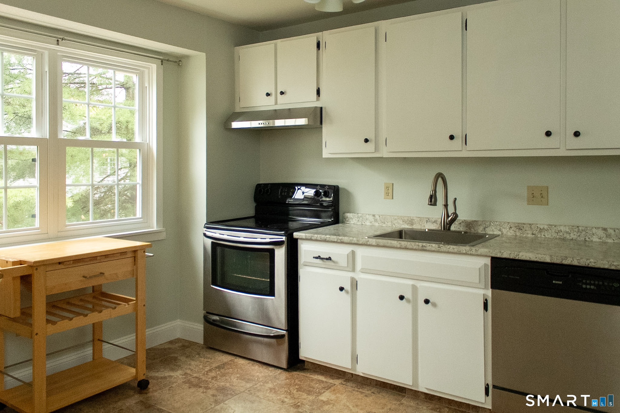 10 Georgetown Drive, Unit J Enfield, CT 06082 - Photo 2 of 15 a kitchen with granite countertop white cabinets and a stove