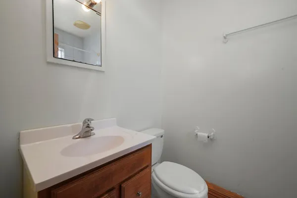 a bathroom with a sink a toilet and mirror