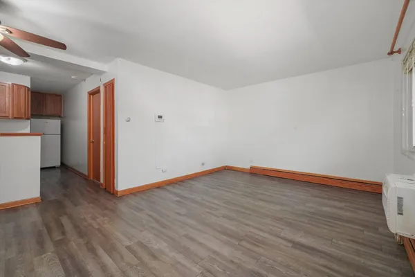 a view of empty room with wooden floor