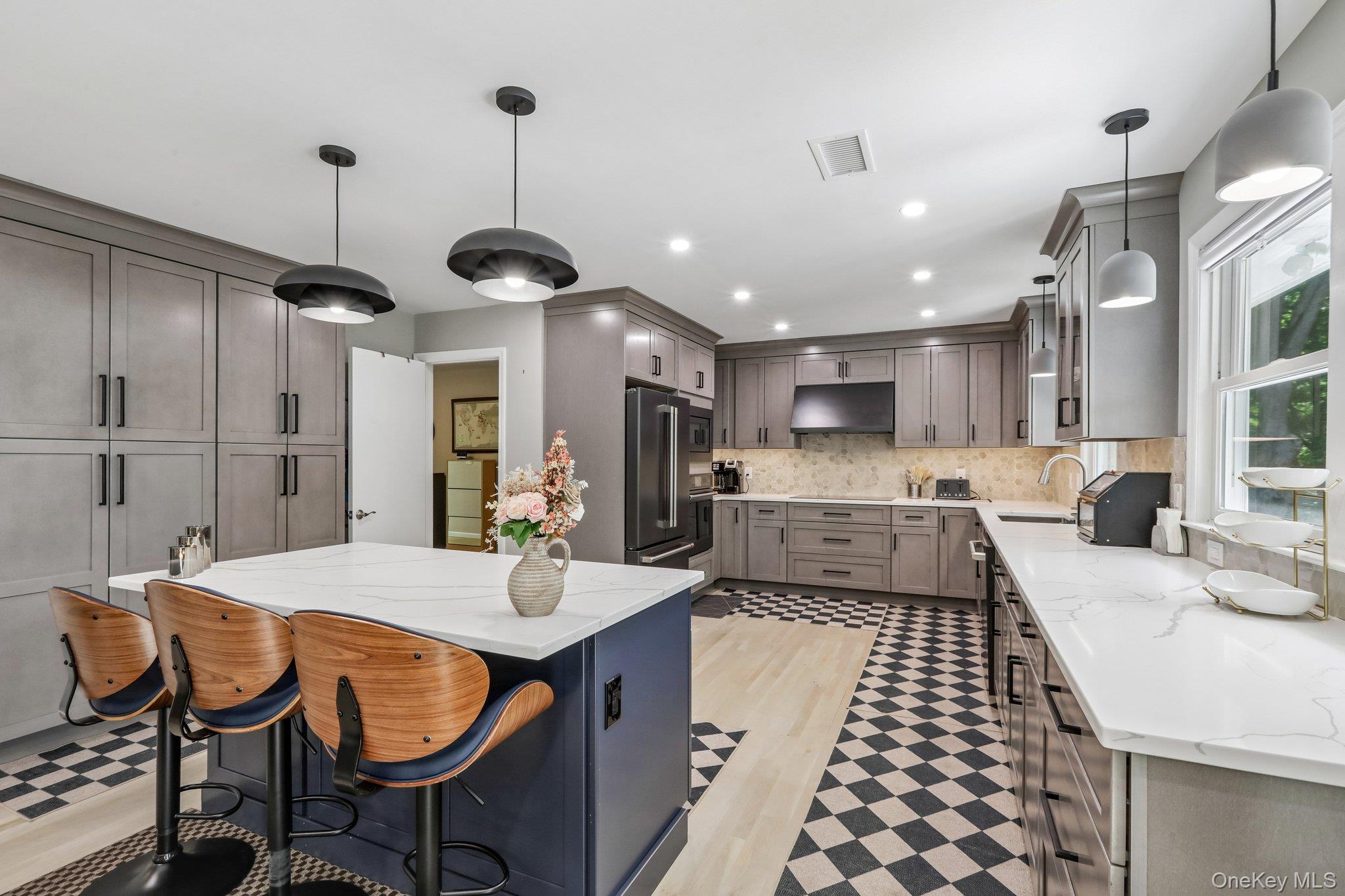 62 Mohegan Road Larchmont, NY 10538 - Photo 23 of 46 a kitchen with stainless steel appliances kitchen island granite countertop a sink and cabinets