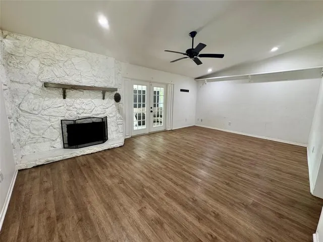 wooden floor in an empty room with a fireplace
