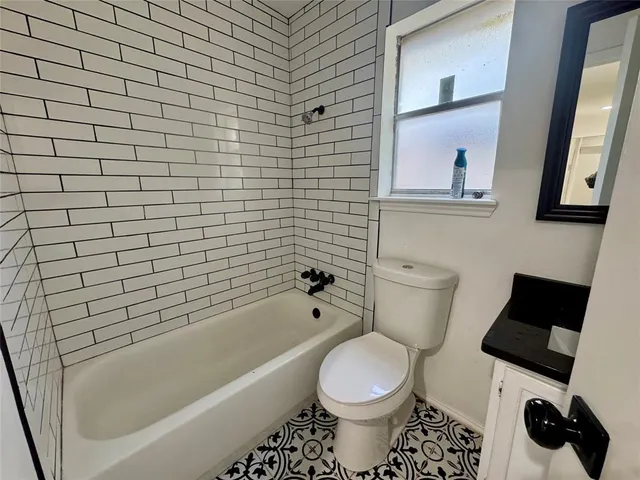 a bathroom with a toilet and a bathtub