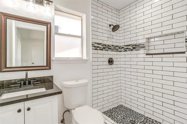 a bathroom with a sink toilet and shower