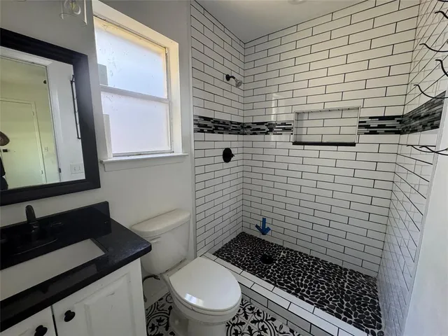 a bathroom with a toilet and a shower