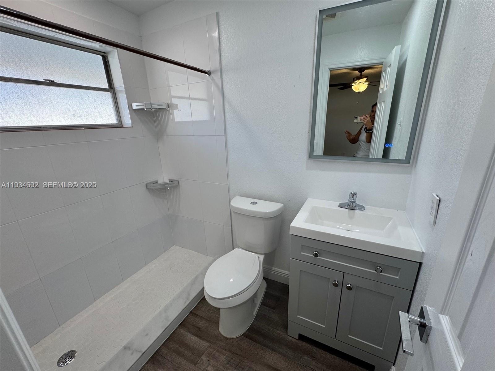 100 Southwest 9th Street, Unit B Hallandale Beach, FL 33009 - Photo 14 of 17 a bathroom with a sink a toilet and shower