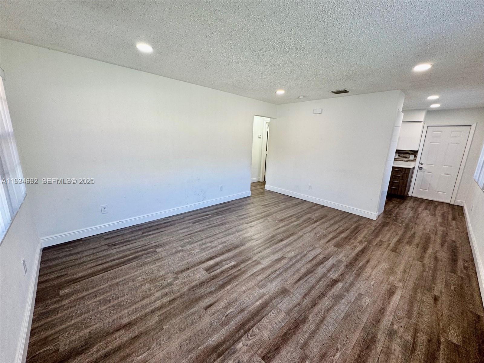 100 Southwest 9th Street, Unit B Hallandale Beach, FL 33009 - Photo 7 of 17 a view of a room with wooden floor