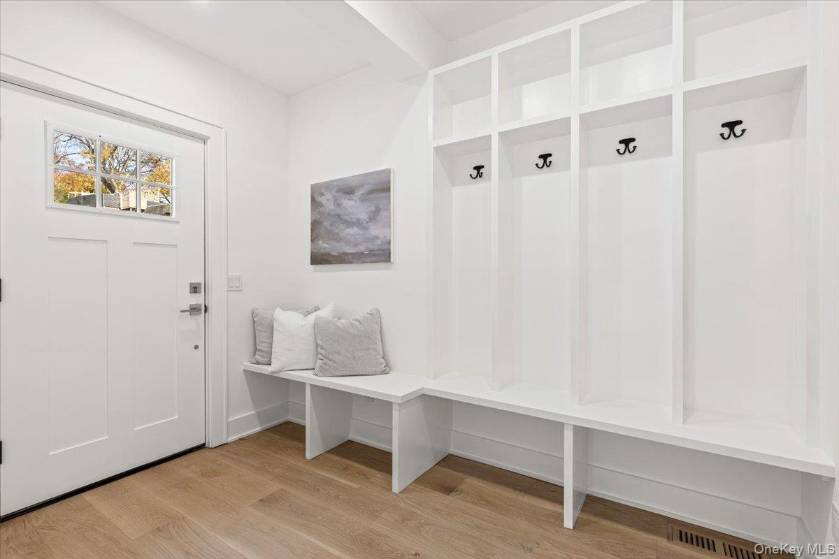 60 Grapal Street Rye, NY 10580 - Photo 8 of 36 a hallway that has a window and a table in it