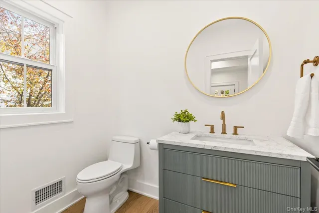 a hallway that has a window and a table in it