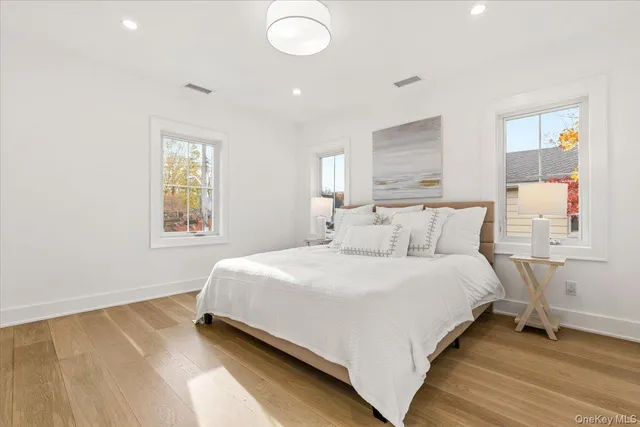 a bathroom with a granite countertop toilet sink and mirror