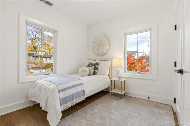 a bed sitting in a bedroom next to a window