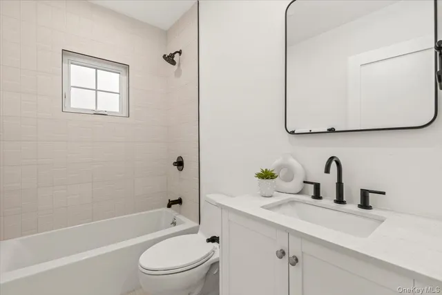 a bathroom with a sink a toilet and bathtub
