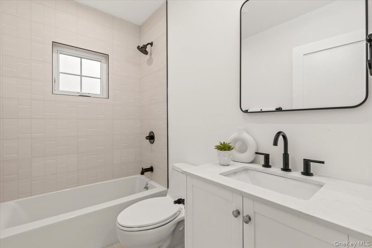 60 Grapal Street Rye, NY 10580 - Photo 14 of 36 a bathroom with a sink a toilet and bathtub
