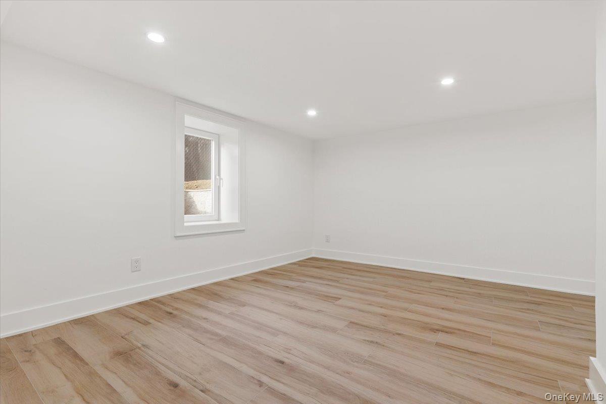 60 Grapal Street Rye, NY 10580 - Photo 19 of 36 an empty room with wooden floor and windows