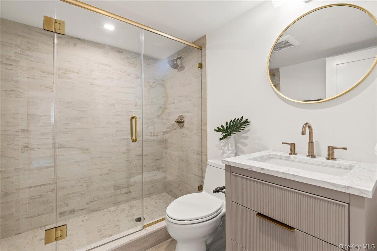 60 Grapal Street Rye, NY 10580 - Photo 20 of 36 a bathroom with a sink a toilet and a mirror