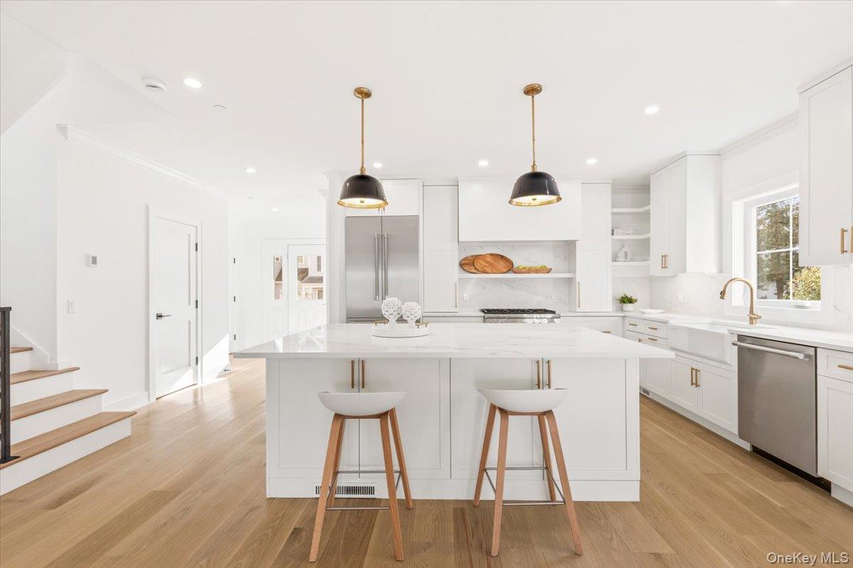 60 Grapal Street Rye, NY 10580 - Photo 3 of 36 a kitchen with kitchen island granite countertop a sink a stove a dining table and chairs