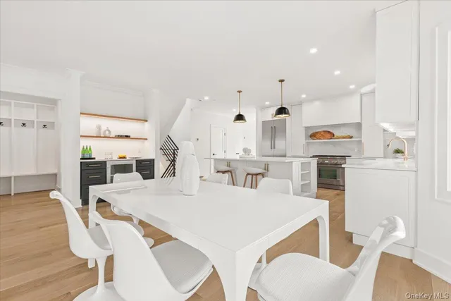 a kitchen with stainless steel appliances kitchen island granite countertop a stove a sink and a wooden floors