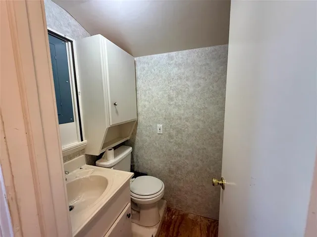 a bathroom with a sink and toilet