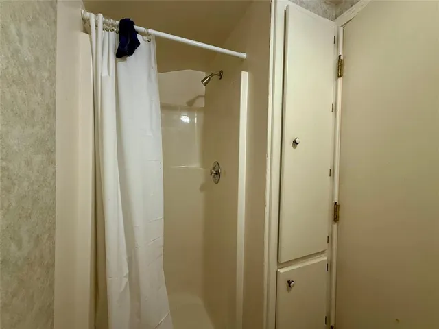 a bathroom with a glass door shower