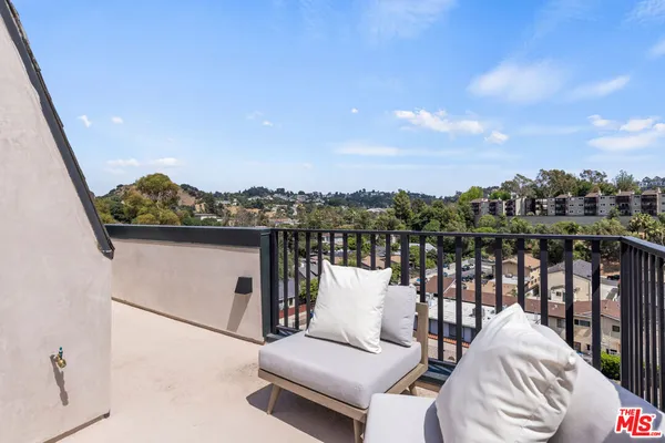 a balcony with furniture and city view