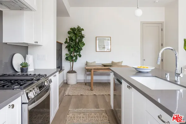 a kitchen with a sink stove and cabinets