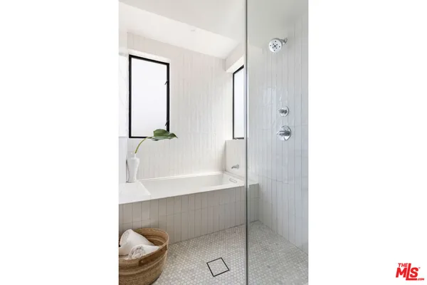 a bathroom with a tub shower and sink