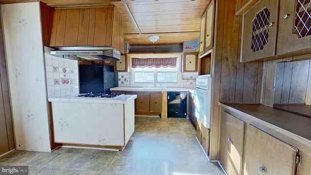 a kitchen with stainless steel appliances granite countertop a stove and a refrigerator