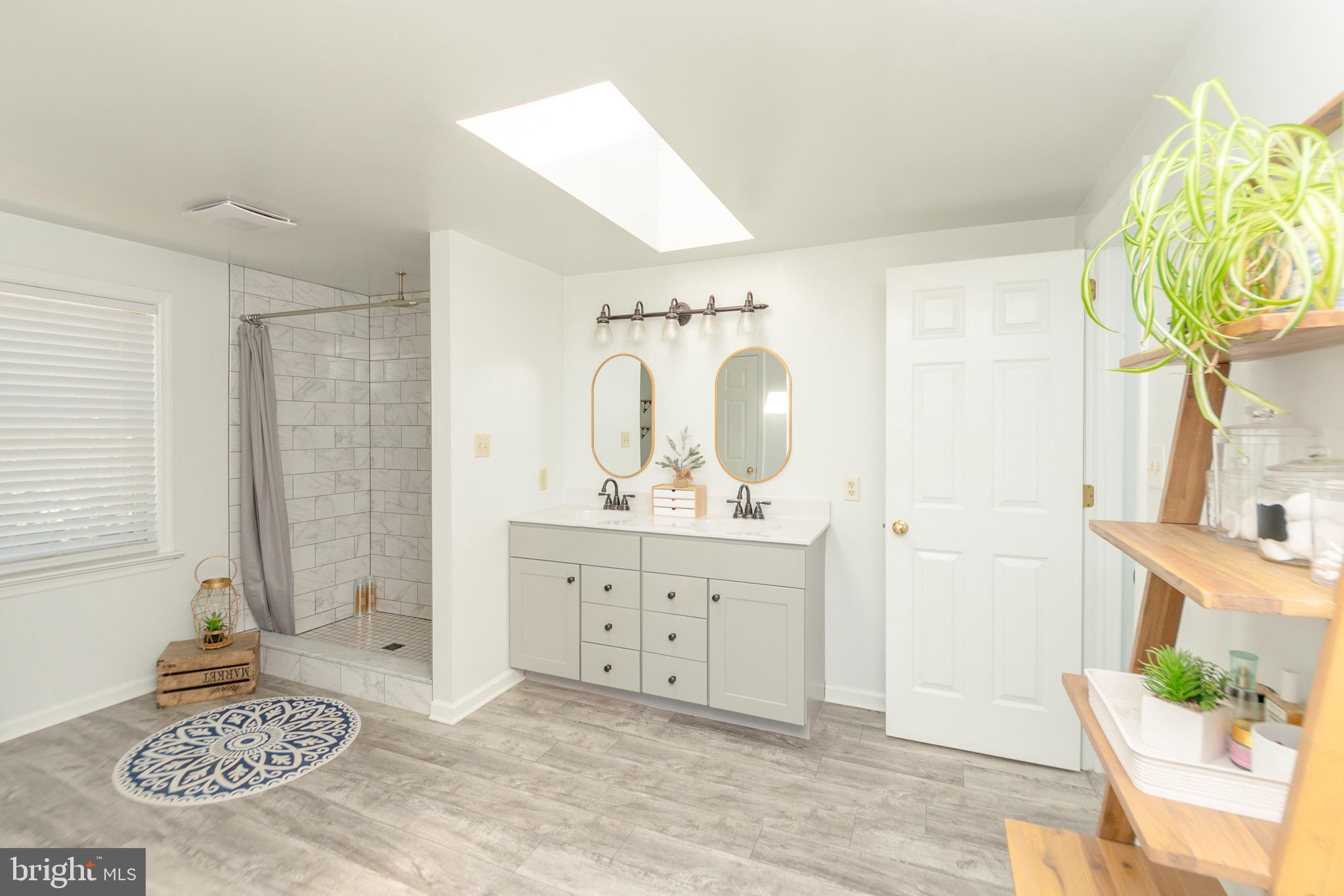 1553 White Oak Road Strasburg, PA 17579 - Photo 19 of 52 a spacious bathroom with a granite countertop sink a mirror and shower