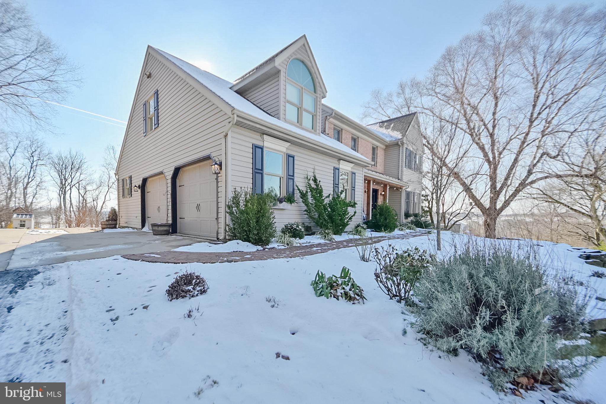 1553 White Oak Road Strasburg, PA 17579 - Photo 2 of 52 a front view of a house with garden