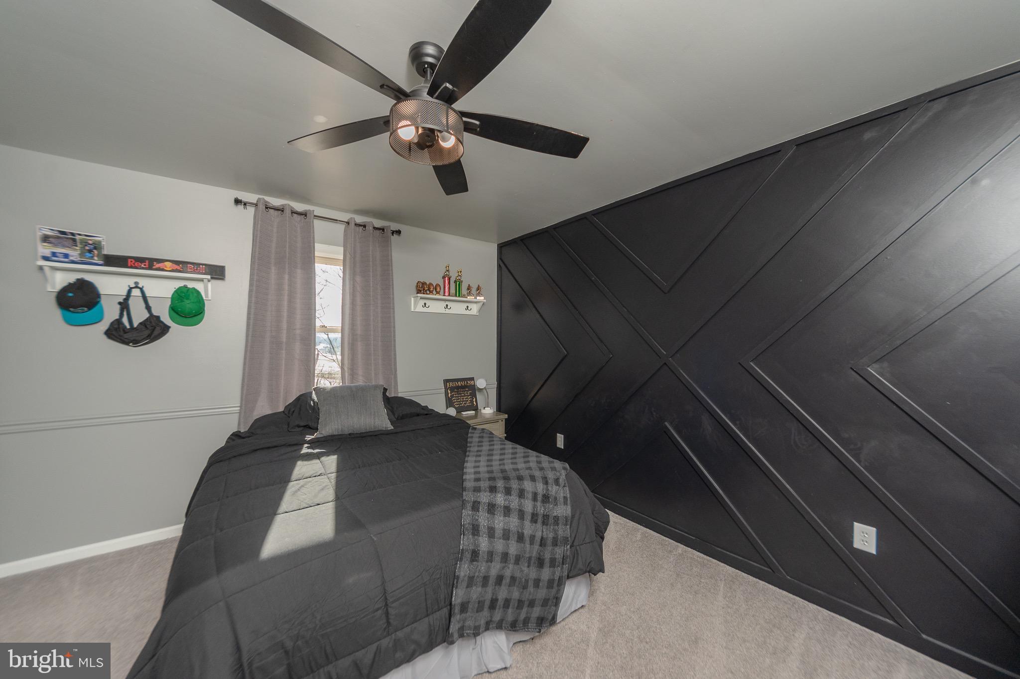 1553 White Oak Road Strasburg, PA 17579 - Photo 22 of 52 a bedroom with a bed and a chandelier