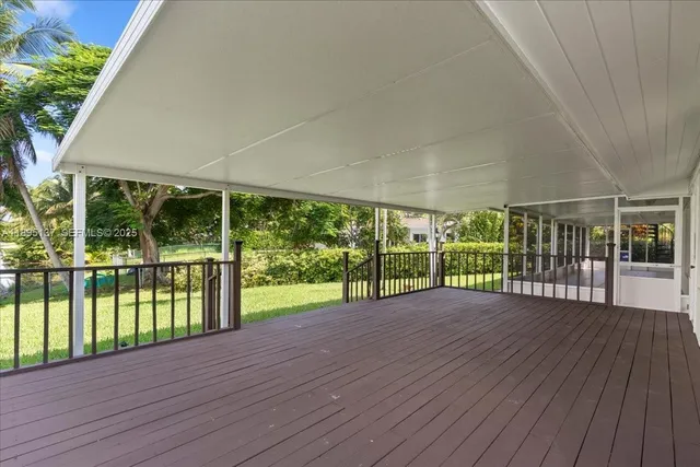a view of porch with wooden floor and floor to ceiling window