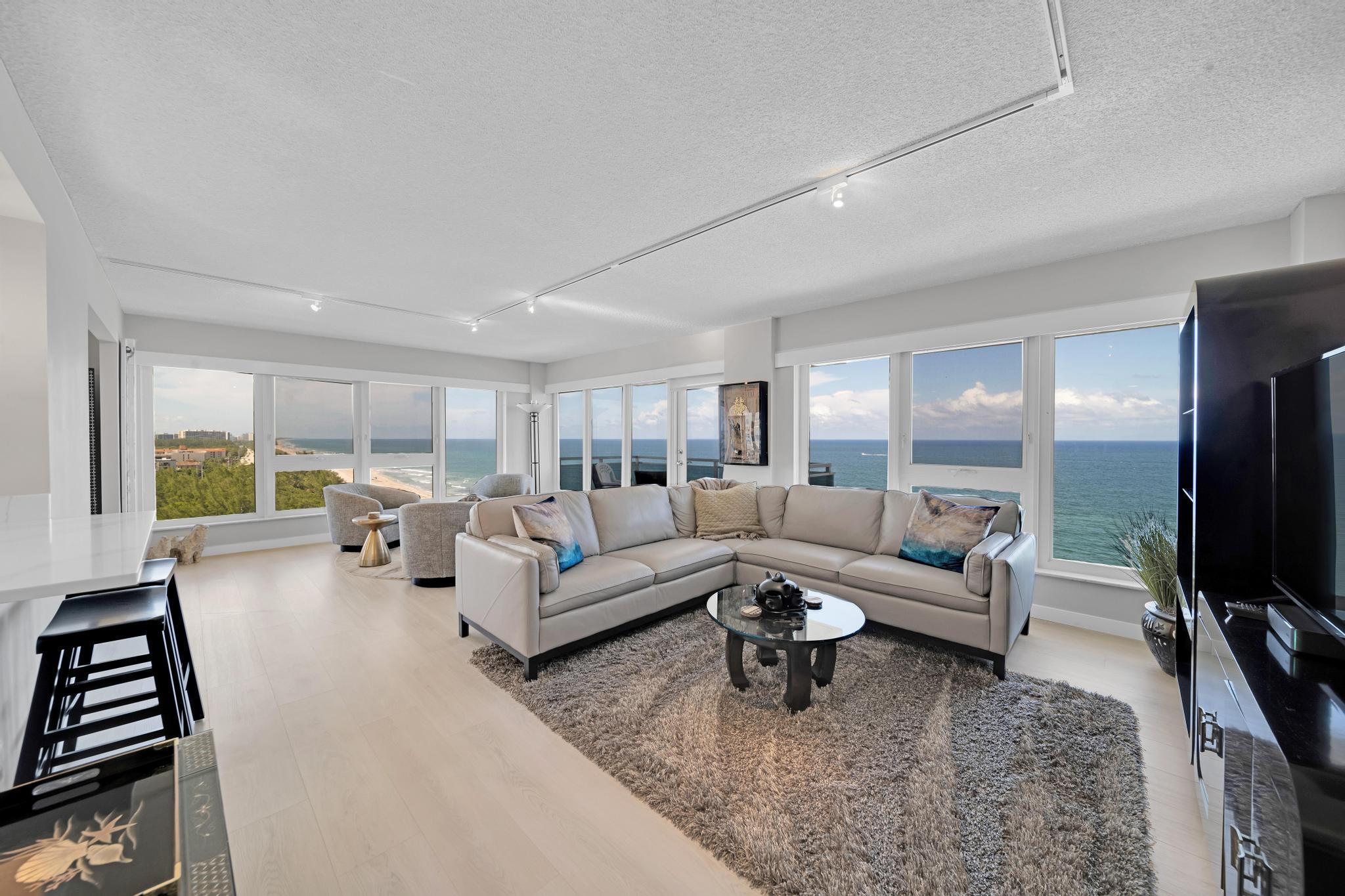 2066 North Ocean Boulevard, Unit 12NE Boca Raton, FL 33431 - Photo 12 of 53 a living room with furniture and a flat screen tv