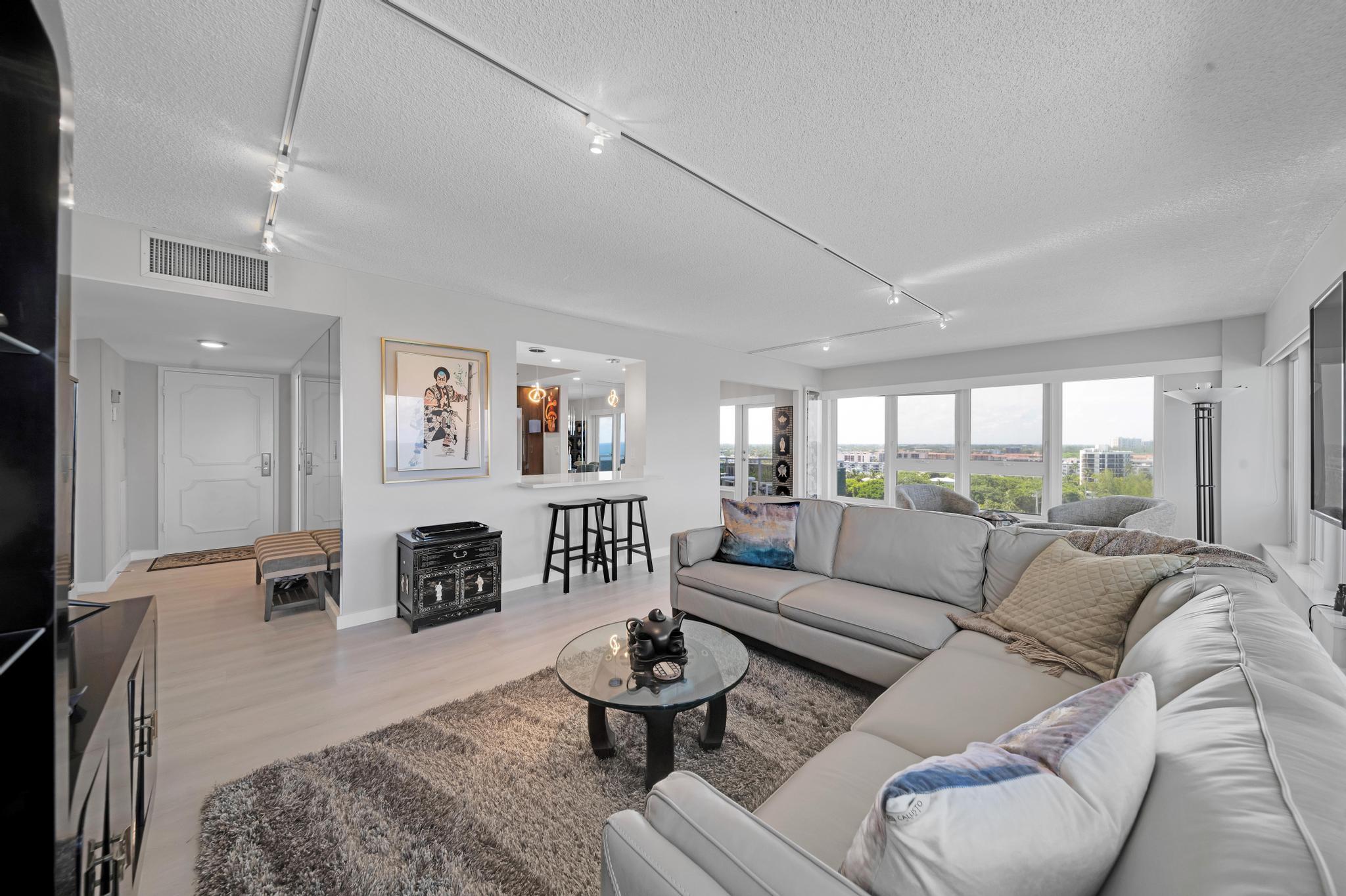 2066 North Ocean Boulevard, Unit 12NE Boca Raton, FL 33431 - Photo 13 of 53 a living room with furniture and a fireplace
