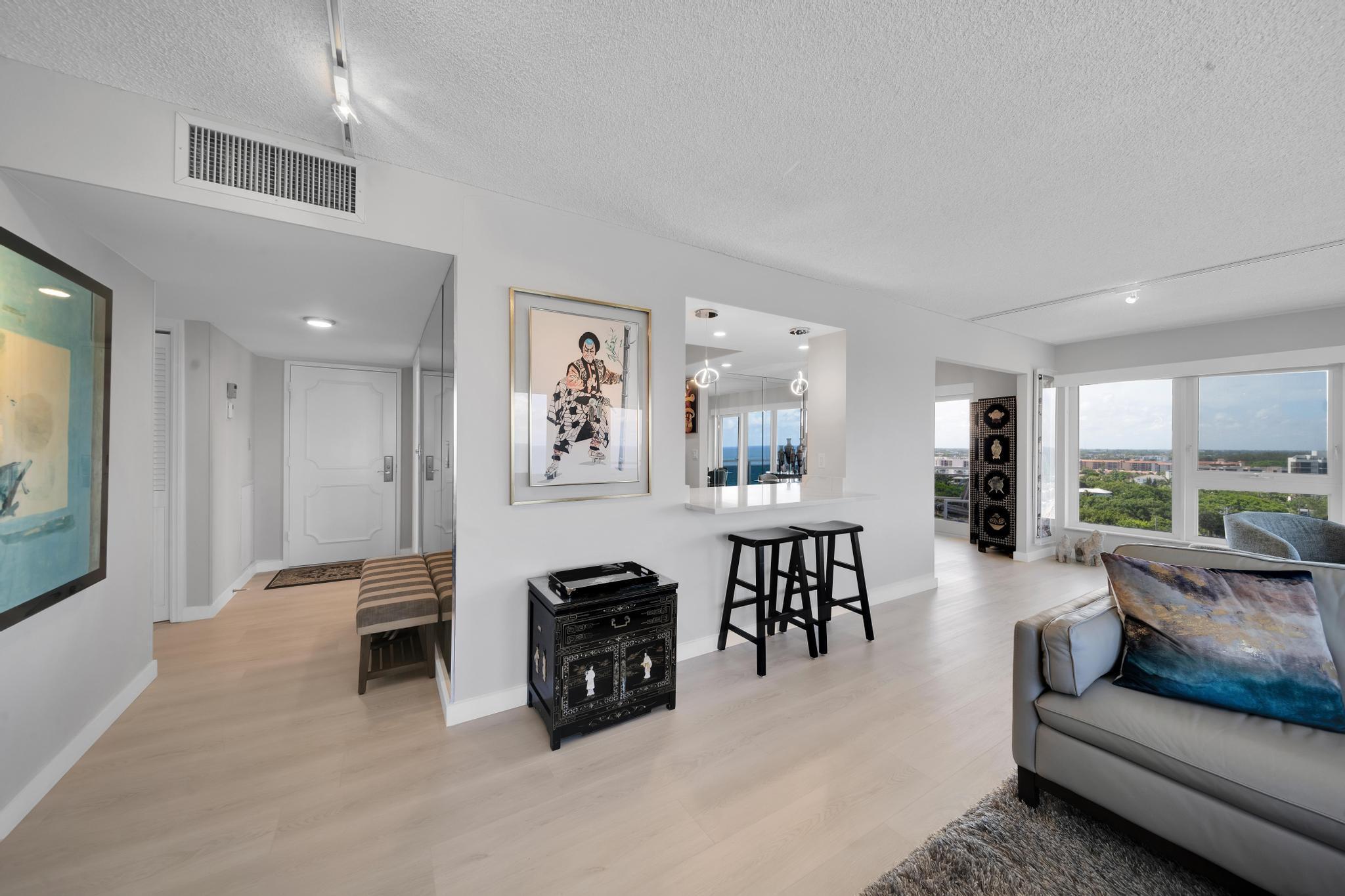 2066 North Ocean Boulevard, Unit 12NE Boca Raton, FL 33431 - Photo 14 of 53 a living room with furniture and a large window