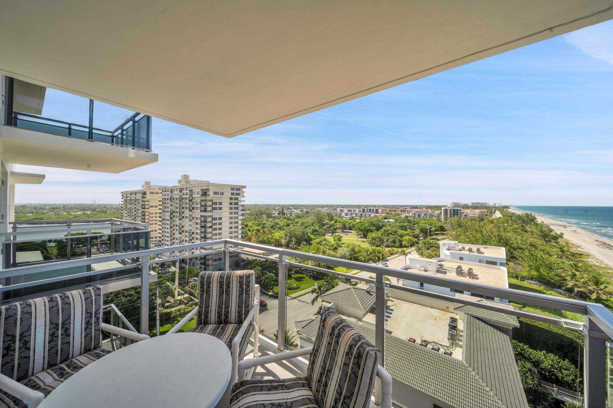 2066 North Ocean Boulevard, Unit 12NE Boca Raton, FL 33431 - Photo 22 of 53 a view of a city from a balcony with furniture