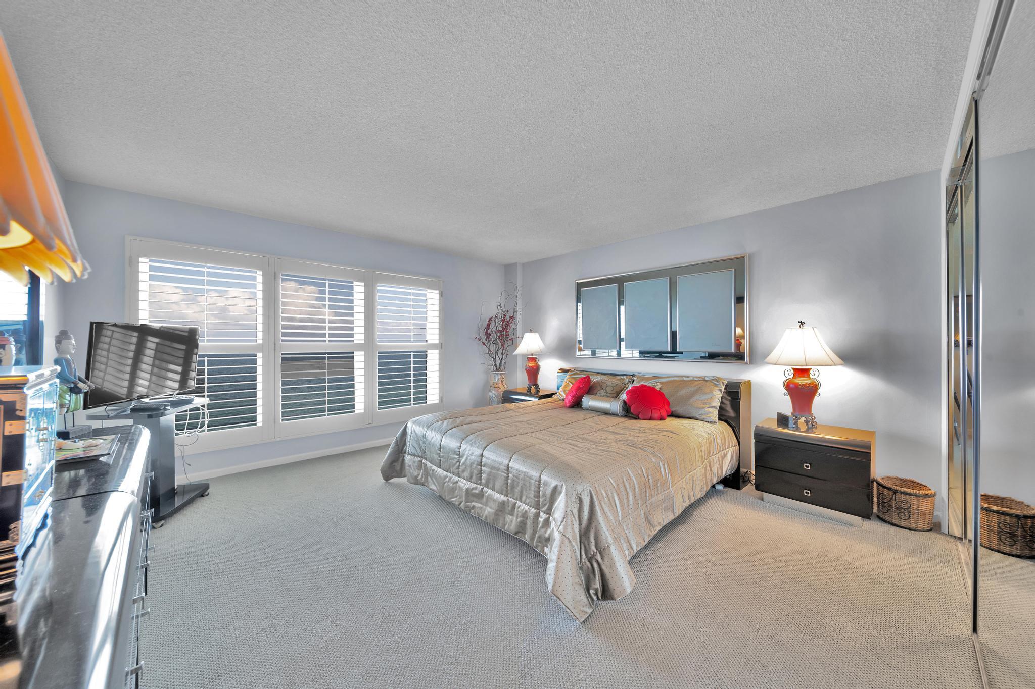 2066 North Ocean Boulevard, Unit 12NE Boca Raton, FL 33431 - Photo 27 of 53 a bedroom with a bed and a couch