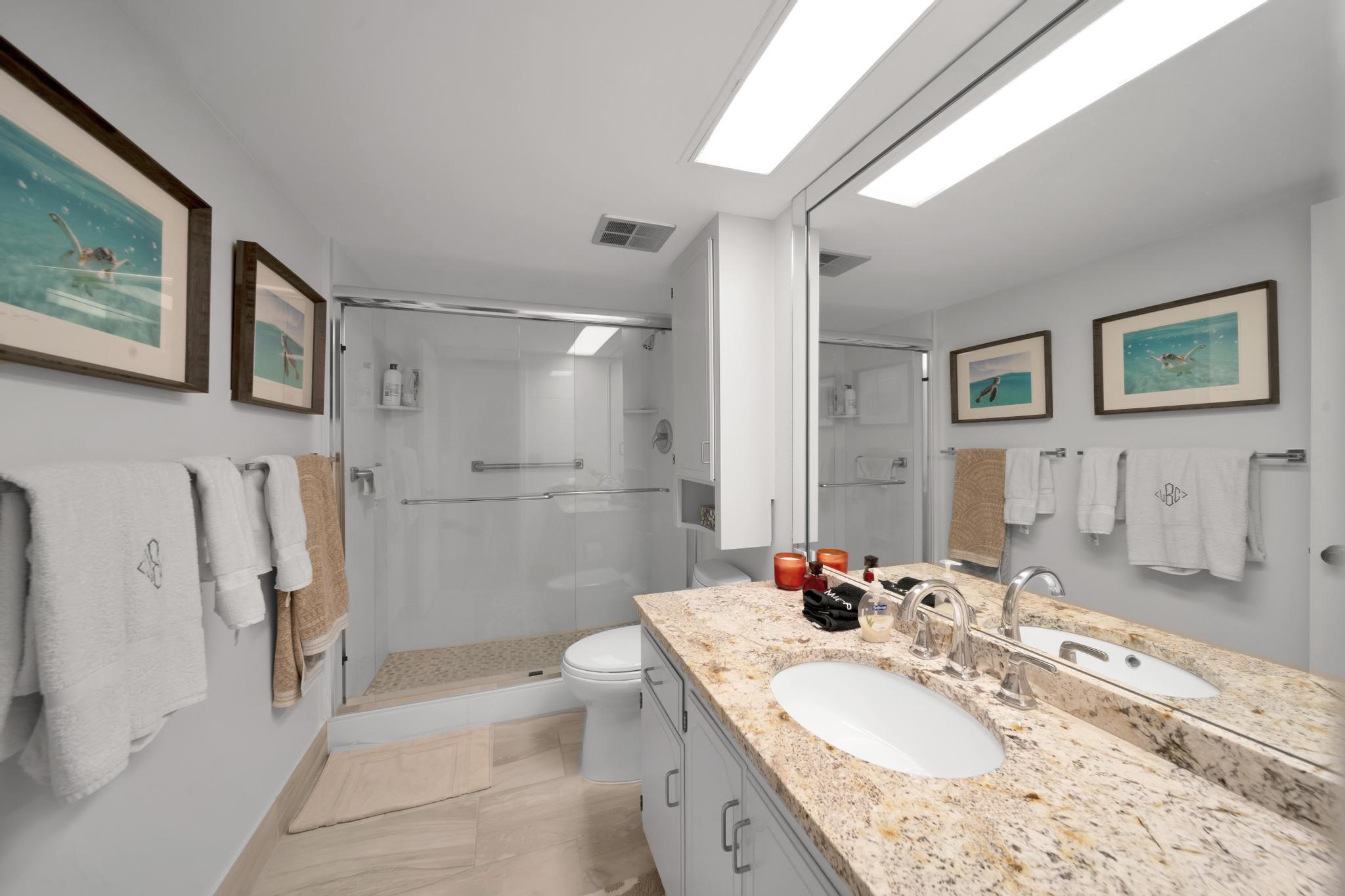 2066 North Ocean Boulevard, Unit 12NE Boca Raton, FL 33431 - Photo 29 of 53 a bathroom with a granite countertop tub sink and mirror