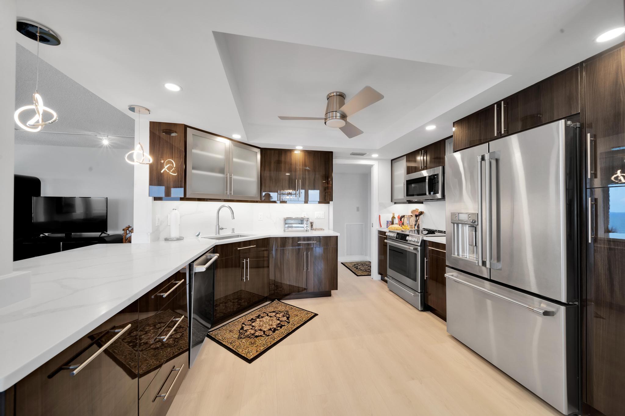 2066 North Ocean Boulevard, Unit 12NE Boca Raton, FL 33431 - Photo 3 of 53 a kitchen with stainless steel appliances a refrigerator sink and microwave
