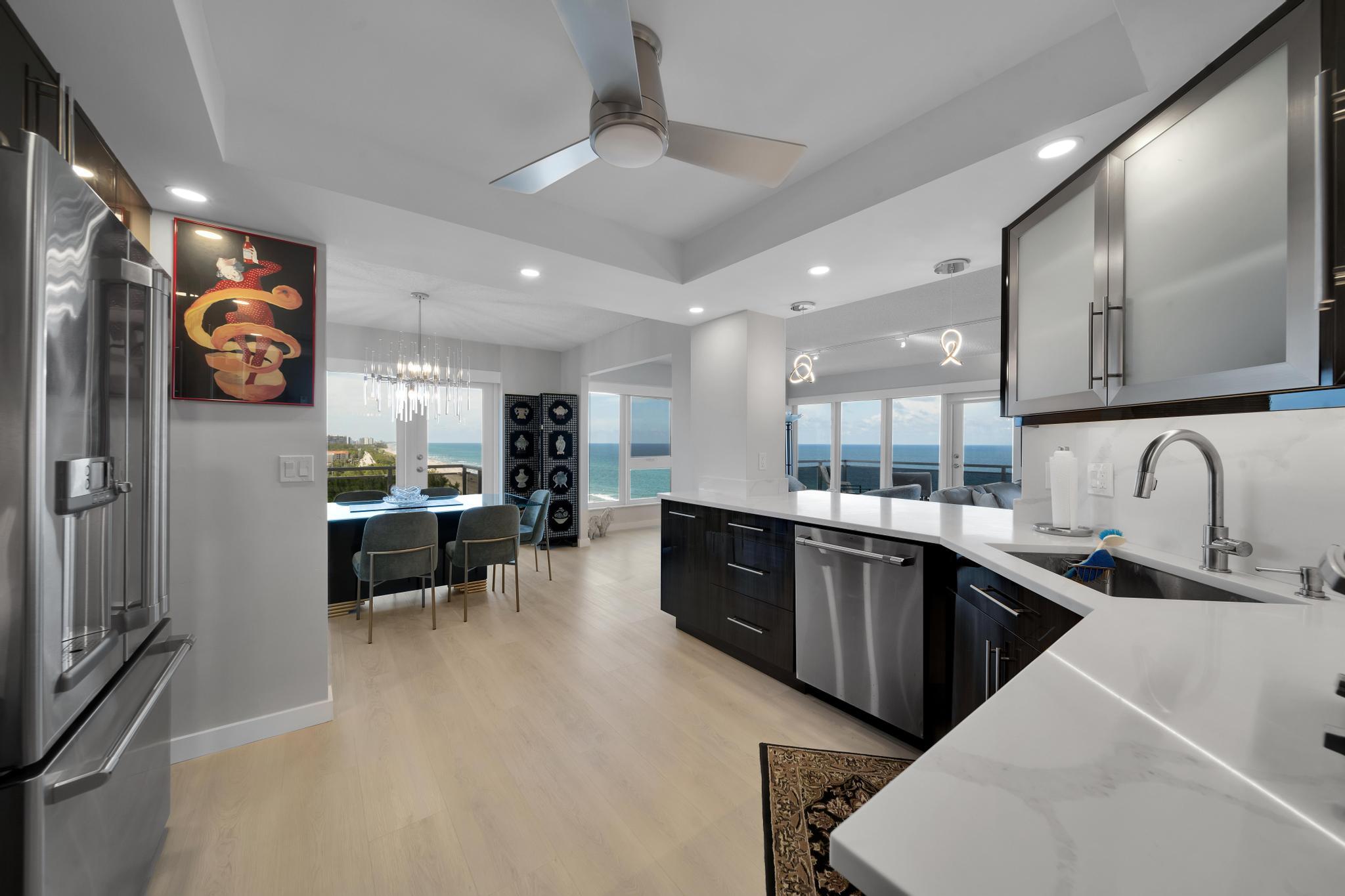 2066 North Ocean Boulevard, Unit 12NE Boca Raton, FL 33431 - Photo 4 of 53 a kitchen with stainless steel appliances kitchen island granite countertop a sink and cabinets