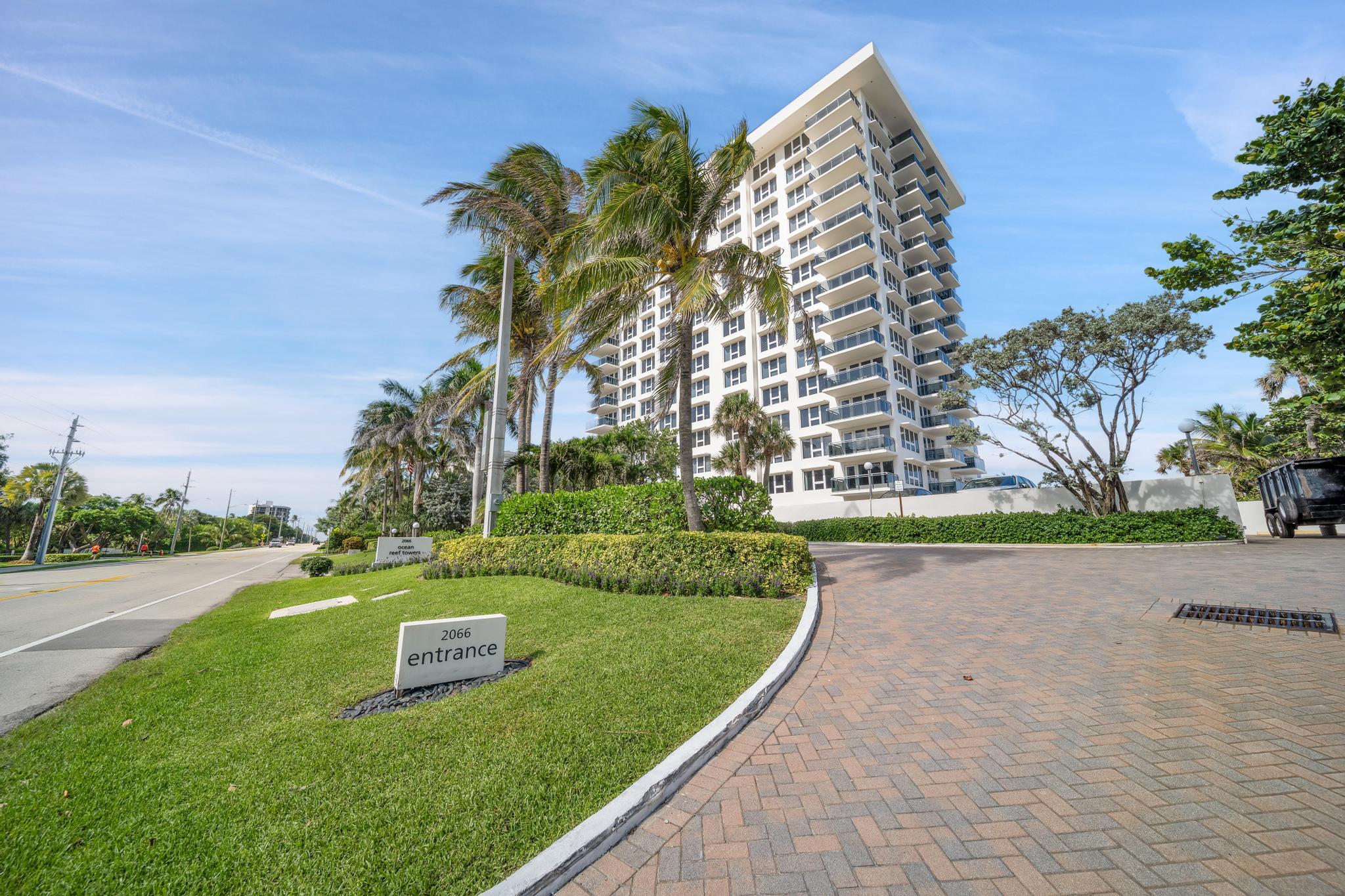 2066 North Ocean Boulevard, Unit 12NE Boca Raton, FL 33431 - Photo 50 of 53 a view of a multi story residential apartment building with a yard