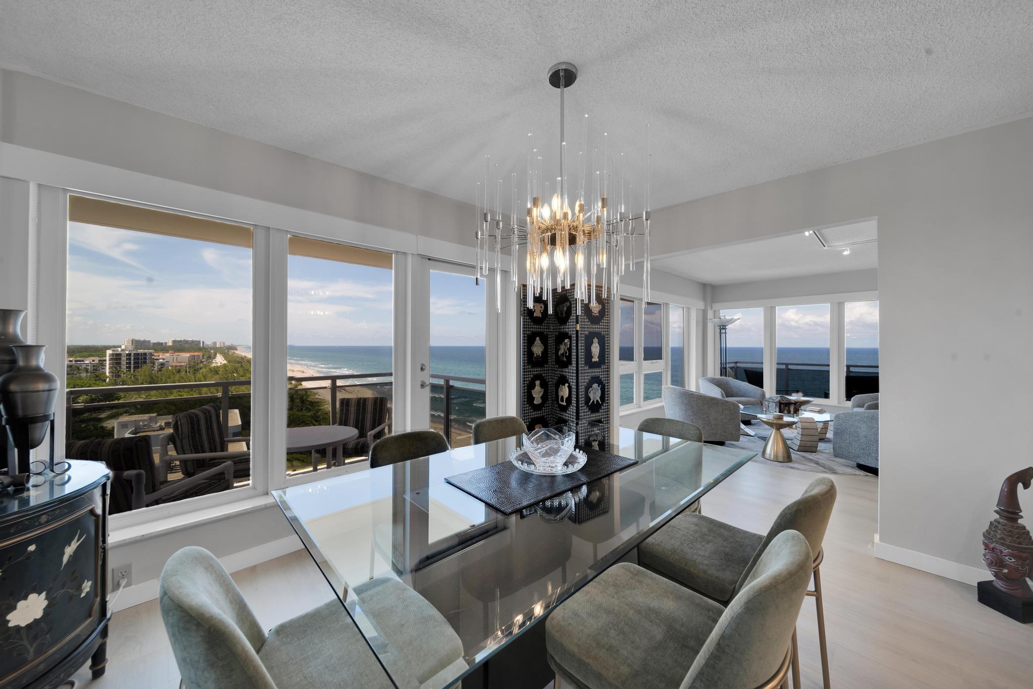 2066 North Ocean Boulevard, Unit 12NE Boca Raton, FL 33431 - Photo 5 of 53 a living room with furniture and a chandelier