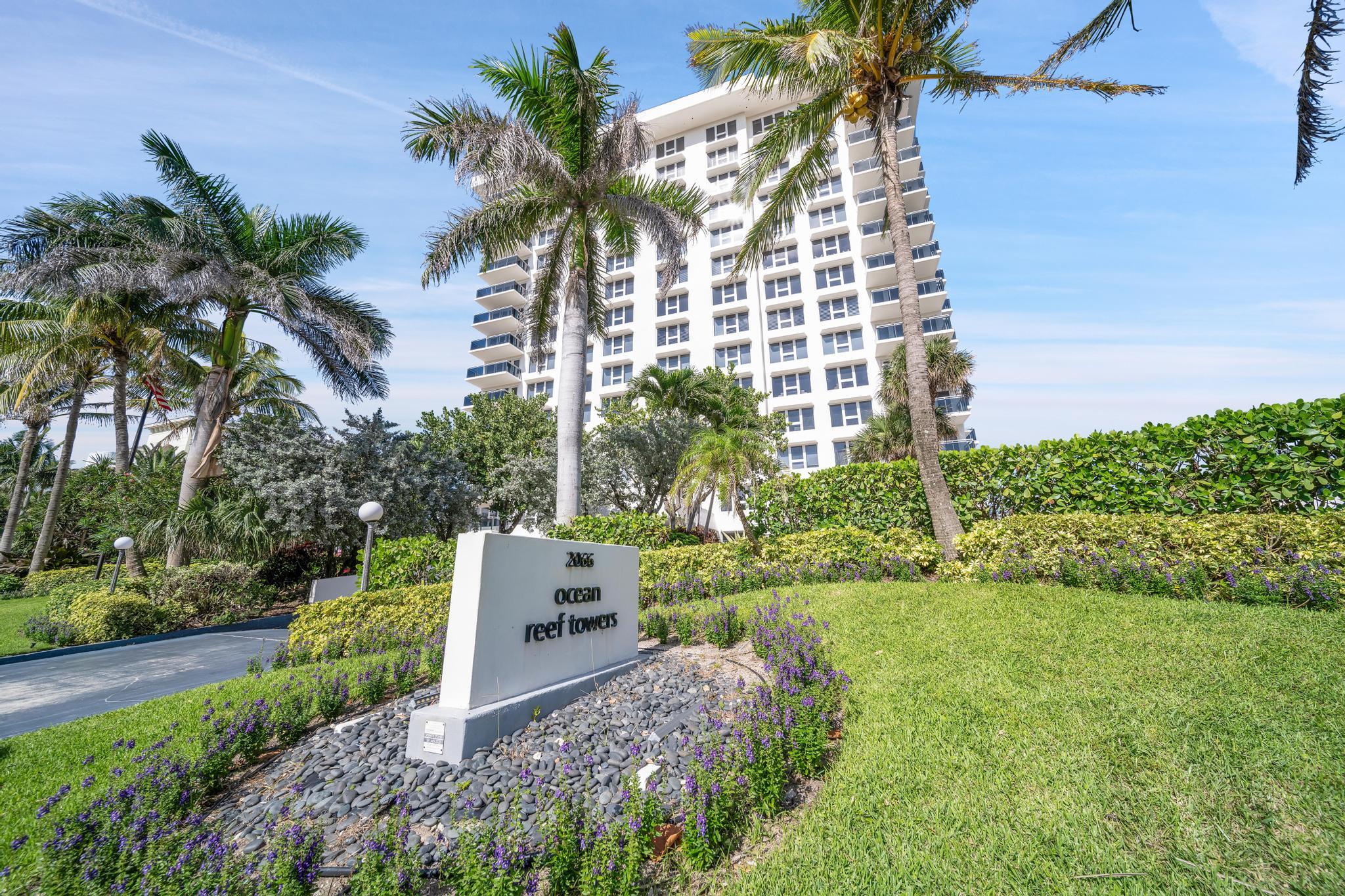 2066 North Ocean Boulevard, Unit 12NE Boca Raton, FL 33431 - Photo 51 of 53 a front view of a house with a yard and potted plants
