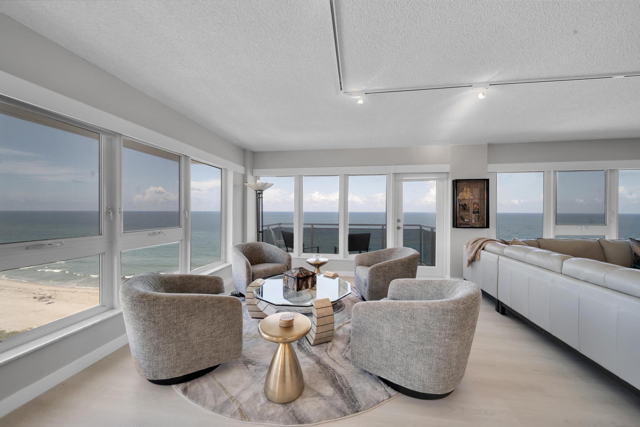 2066 North Ocean Boulevard, Unit 12NE Boca Raton, FL 33431 - Photo 7 of 53 a living room with furniture and large windows