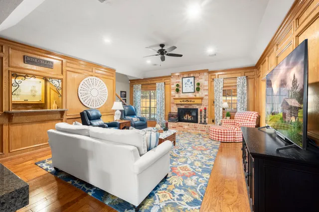 a living room with fireplace furniture and a large window