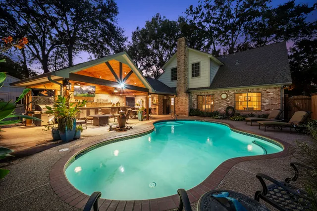 an outdoor space with furniture and swimming pool