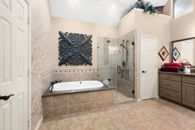a bathroom with a granite countertop sink a toilet and shower