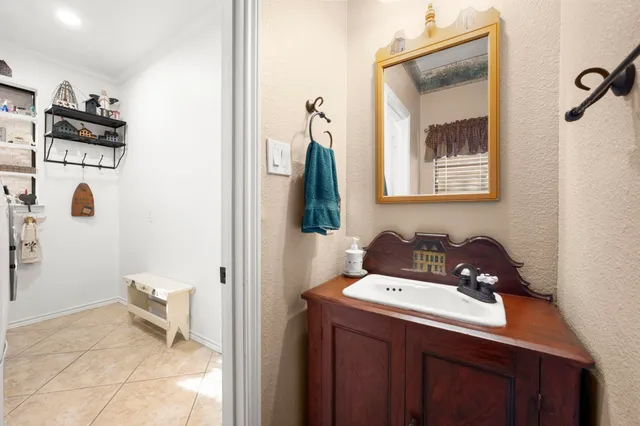 a front view of a house with a garden and tree